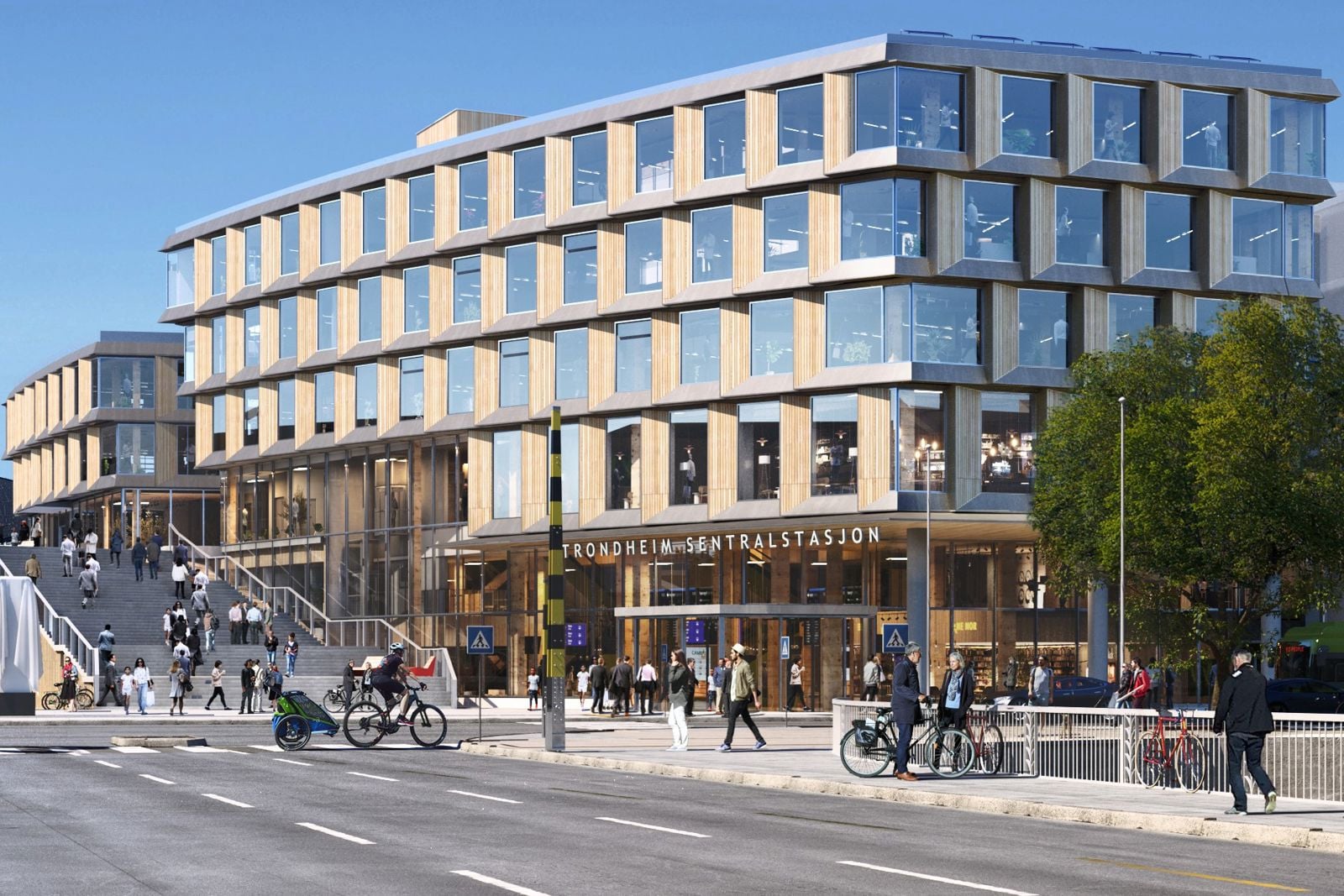 Kollektivterminalen på Trondheim S sett fra litt borti gaten. Det blir stort og med mange vinduer.